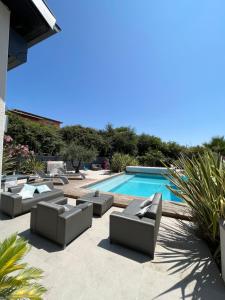 un patio con sofás y una piscina en Villa Les Palmiers, en Flourens