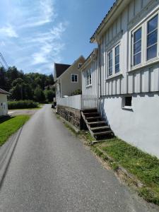 a house on the side of a road at Guesthouse with terrace in Arendal