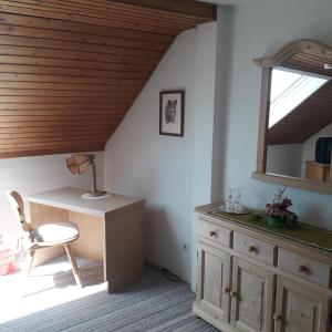 a attic room with a desk and a window at Landhotel Jägerhof in Bischofsgrün