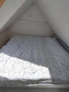 a bed in a small room in a attic at Guesthouse with terrace in Arendal