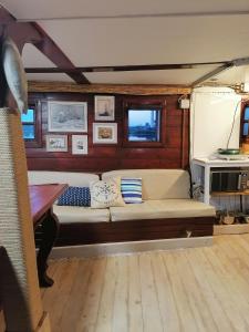 a living room with a couch in a boat at Corabia Santa Marina in Sulina