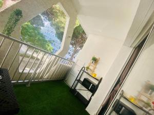 a view of a balcony with green grass at Studio Cosy - 50m PLAGE - Terrasse - centre ville in La Grande-Motte