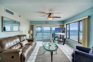 a living room with a couch and a glass table at Arie Dam 304 in St. Pete Beach