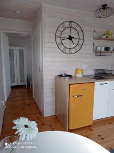 a kitchen with a large clock on the wall at Strefa Kampinos in Brochów