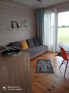 a living room with a couch and a table at Strefa Kampinos in Brochów