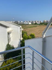 a balcony with stairs and a view of a city at Denize 800 m villamız in Aksu