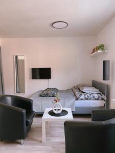 um quarto com uma cama, uma mesa e cadeiras em Cozy Apartment in historical Alt-Lobeda near Uni-Klinik Jena em Jena