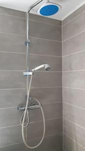 a shower with a shower head in a bathroom at Bună Ziua apartment Tonitza Nic. in Cluj-Napoca