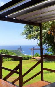 a view of the ocean from the deck of a house at Pousada Vila Nakau in Fernando de Noronha