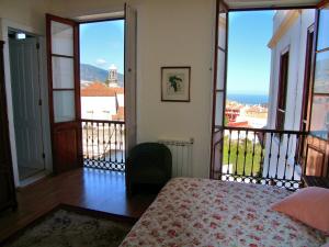 a bedroom with a bed and views of the ocean at Hotel Alhambra in La Orotava