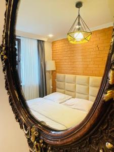 a bedroom with a bed in a mirror at happy home in Borjomi