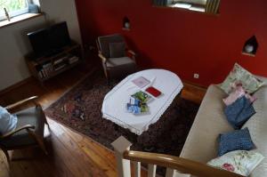 a living room with a couch and a table at La Petite Maison in Sart lez Walhain +10 photos