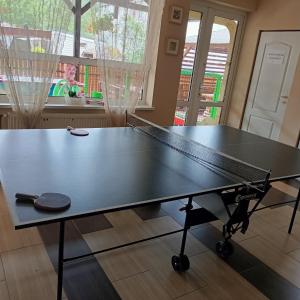 a ping pong table in the middle of a room at Pokoje Gościnne u Marcina in Ostrowo