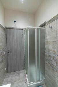 a shower with a glass door in a bathroom at Tampasio Apartment Trapani centro in Trapani +8 photos