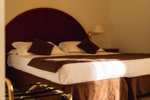 Кровать или кровати в номере Apulia Hotel Taranto Ara Solis