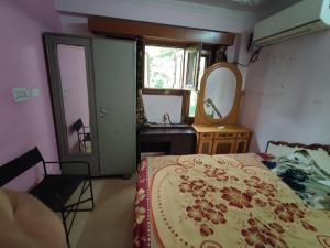 a bedroom with a bed and a dresser and a mirror at Trehan's Residence in New Delhi