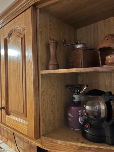 a cabinet with a coffee maker and a blender at Billy's appartment in Preveza