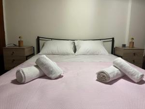 a bedroom with a bed with two towels on it at Billy's appartment in Preveza