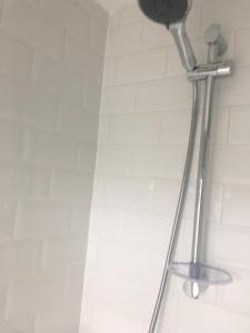 a shower head on the wall of a bathroom at Minook in Thorney