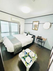 a hotel room with a large bed and a table at 渋谷駅徒歩6分!高速インターネット光回線 in Tokyo