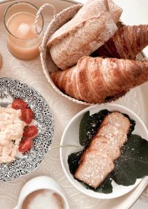 戈夫季永的住宿－La Bâtisse en Blanc，餐桌上摆放着面包和糕点