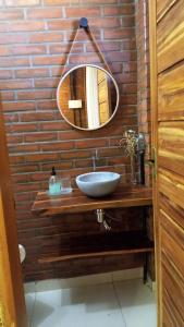 a bathroom with a sink and a mirror at Pousada Bem Viver in Nobres