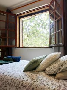a bedroom with a bed with pillows and a window at Villa Les Chariotins in Draguignan +24 photos