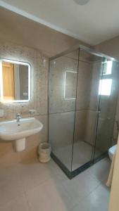 a bathroom with a glass shower and a sink at شقه 175 م للايجار كمباوند ستون ريزيدنس التجمع الخامس القاهره الجديده in Cairo