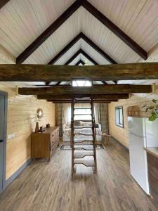 a kitchen with a ladder in the middle of a room at Country House in Vadul lui Carol II