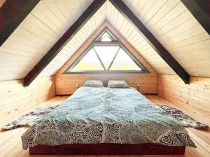 a large bed in a room with a window at Country House in Vadul lui Carol II +5 photos