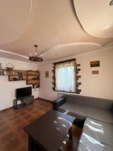 a living room with a couch and a table at Dinadav house in Garni