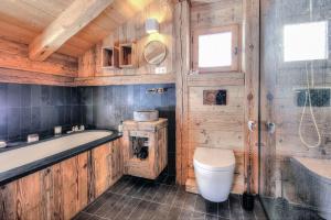 a wooden bathroom with a tub and a toilet at Chalet luxe & calme La Chandelle, 6-12 p, Vue+++ in Saint-Gervais-les-Bains