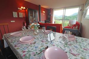 a table with pink plates and glasses on it at Baigorri in El Llano