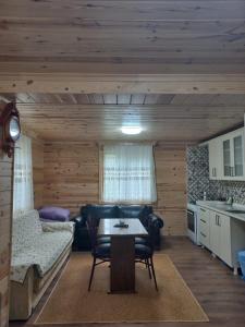 a living room with a couch and a table at Saklı Bahçe Suite in Uzungöl