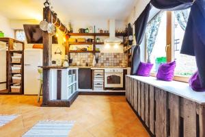 a kitchen with purple pillows and a counter in a room at Lady Lavender House in Balatonfüred +33 photos