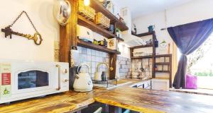 a kitchen with a counter top with a microwave at Lady Lavender House in Balatonfüred