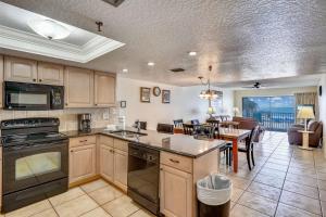 a kitchen and dining room with a dining table at Sand Dollar 107 in Clearwater Beach