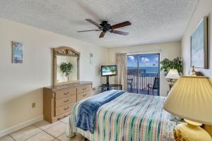 a bedroom with a bed and a ceiling fan at Sand Dollar 107 in Clearwater Beach