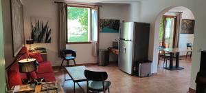a kitchen and a living room with a refrigerator at B&B Auberge Verdon in La Palud-sur-Verdon