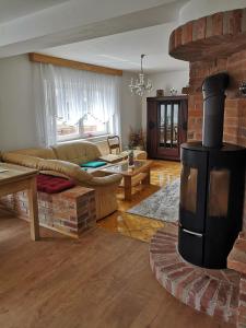 a living room with a fireplace and a couch at Zur Alten Schmiede mit Museum in Rüstungen