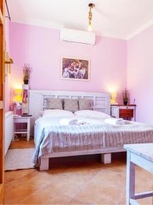 a bedroom with a large bed with purple walls at Lady Lavender House in Balatonfüred