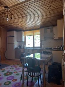 a kitchen with a table and chairs in a room at Saklı Bahçe Suite in Uzungöl