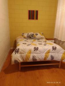 a bed with a stuffed animal laying on top of it at Casa Sara en San Blas in Cusco