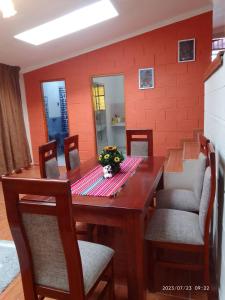 a dining room with a wooden table and chairs at Casa Sara en San Blas in Cusco