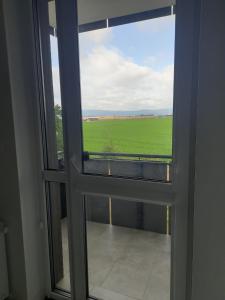 an open window with a view of a green field at APARTAMENT OLIWIER in Kłodzko