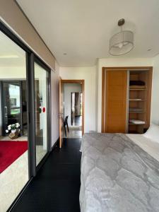 a bedroom with a large bed and a sliding glass door at Luxuary appartment in Agadir Bay in Agadir