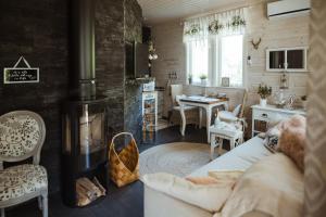 a living room with a couch and a fireplace at Guest House Marjala in Kotka