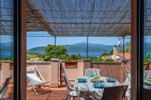 a patio with a table and chairs and a view of the water at Residenza Elbamare in Capoliveri