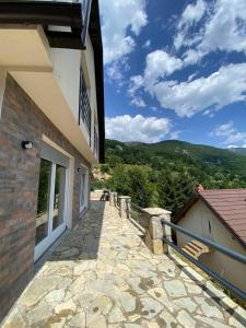 a balcony of a house with a view of the mountains at Villat Twin’s in Peje