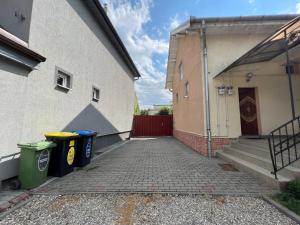 an alley with two trash cans next to a building at Casa LINDA in Turda